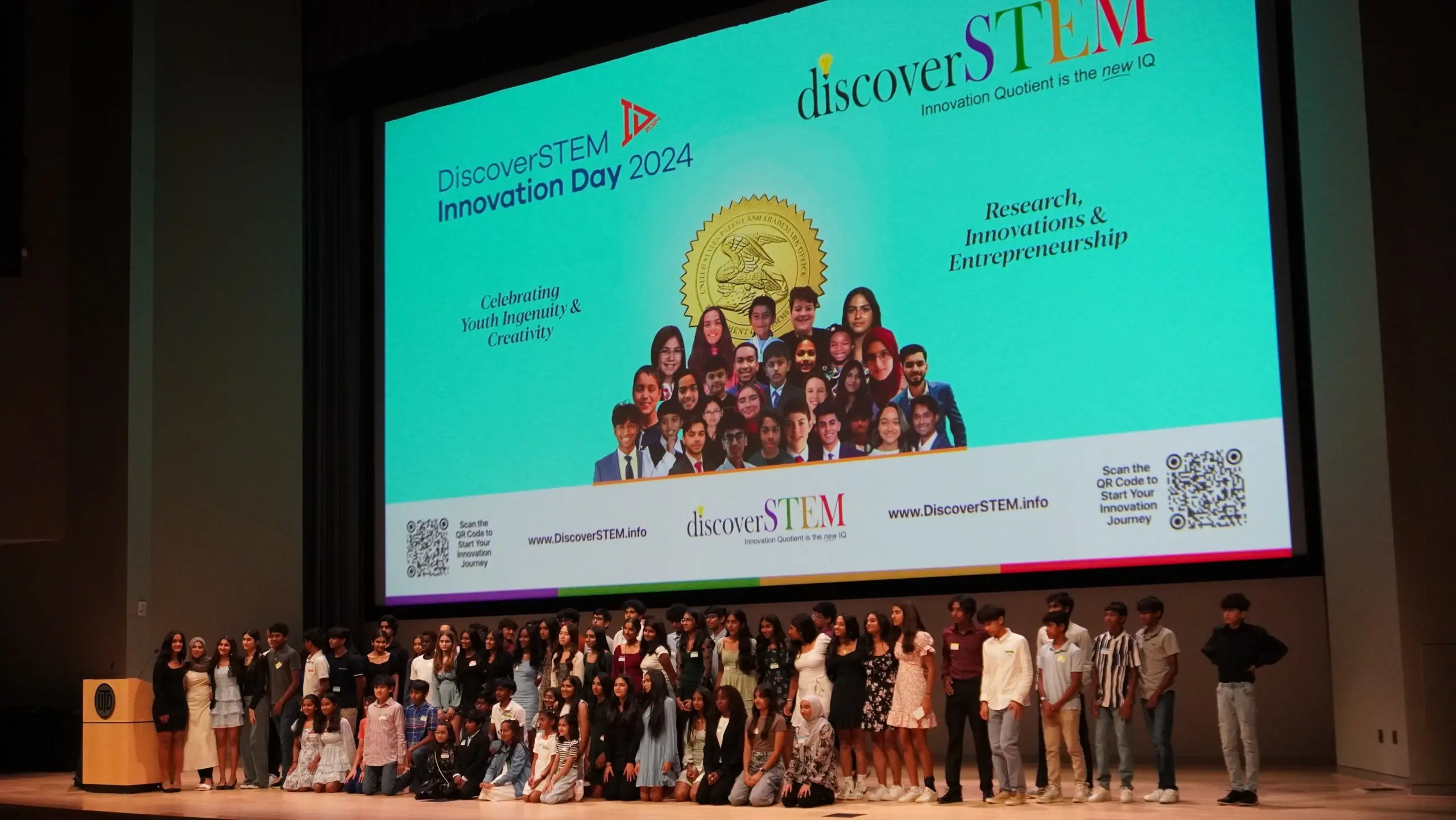 Kids on stage posing for photograph with DiscoverSTEM &