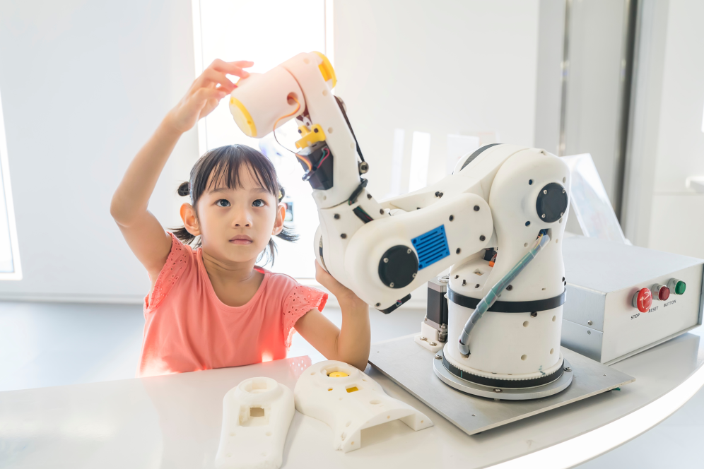 A Young Girl working with robotic arm